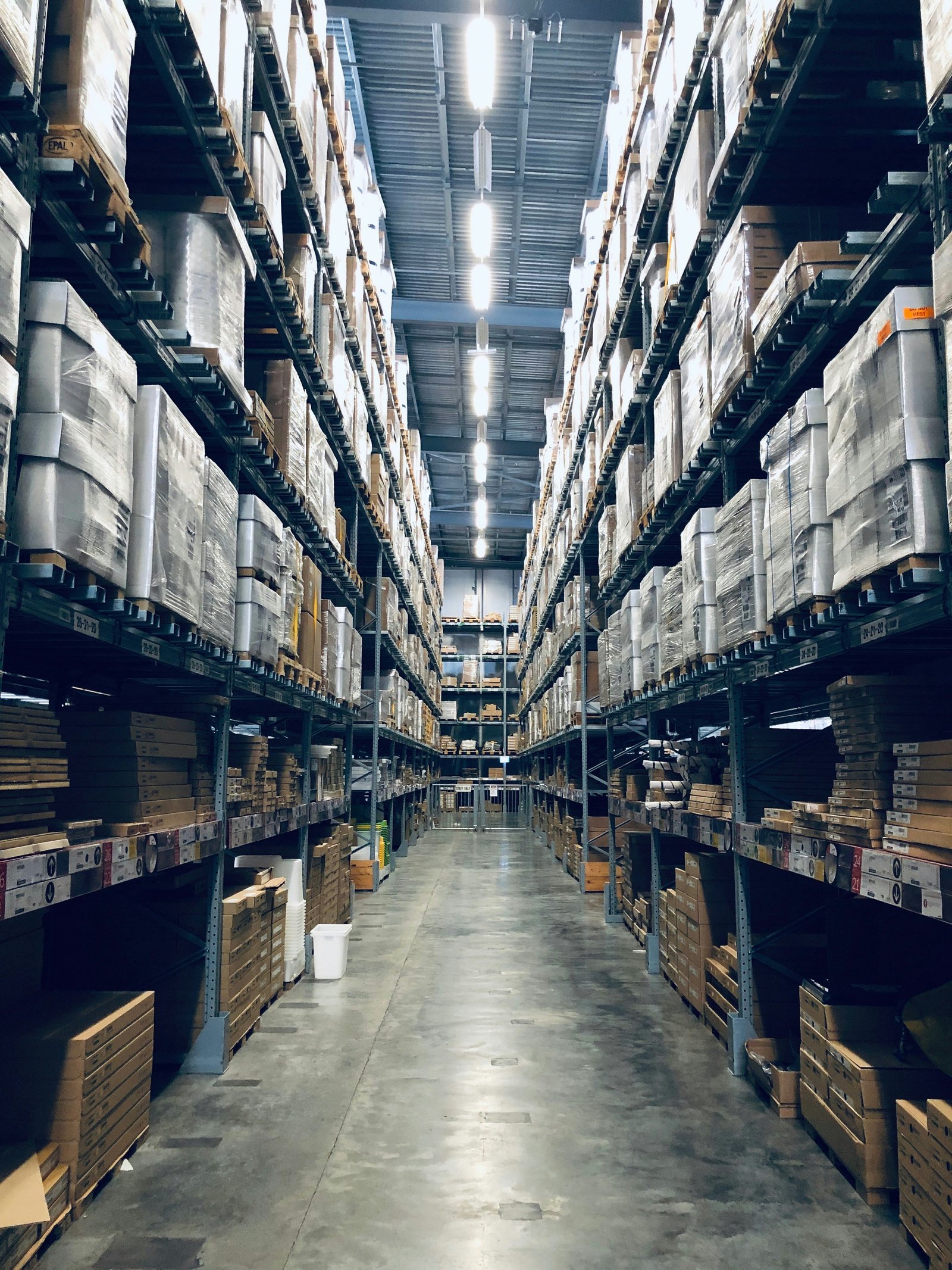 Warehouse aisle stacked with pallets of purchased stock