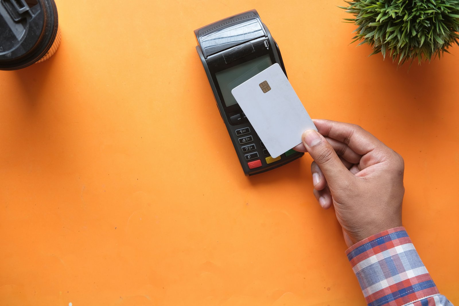 Customer tapping a card to pay at a pharmacy retail billing counter