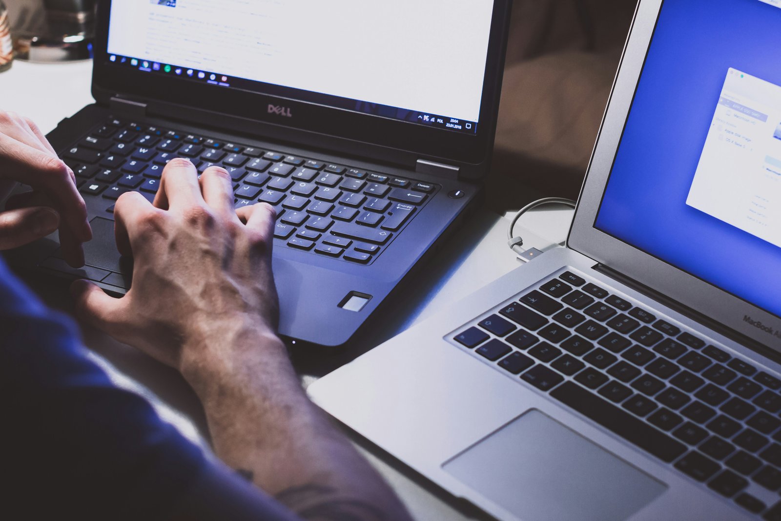 Two laptops side by side transferring data
